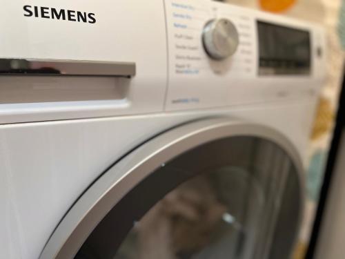 a white washing machine with the words gleams on it at 250 City Road 2 Bollinder Place EC1V 2AH 2bed LUXURY apartments-this is full address in London