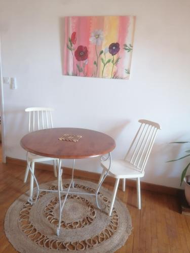 - une table en bois et 2 chaises dans une chambre dans l'établissement Fleur, à Salles-Curan
