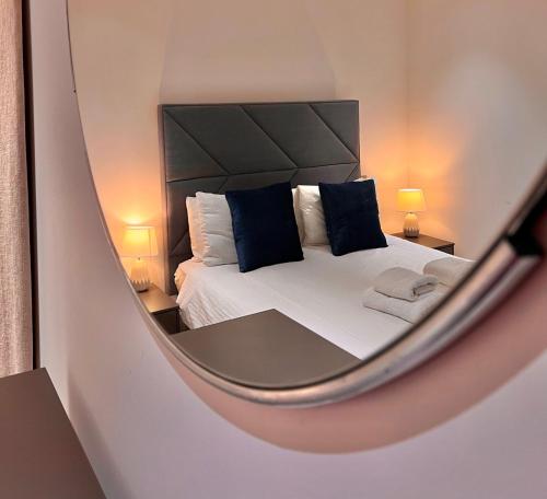 a mirror reflection of a bedroom with a bed at 250 City Road 2 Bollinder Place EC1V 2AH 2bed LUXURY apartments-this is full address in London