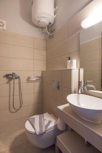 a bathroom with a sink and a toilet and a shower at 5 Keys in Zakynthos Town