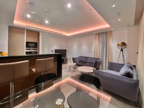 a living room with a couch and chairs and a table at 250 City Road 2 Bollinder Place EC1V 2AH 2bed LUXURY apartments-this is full address in London