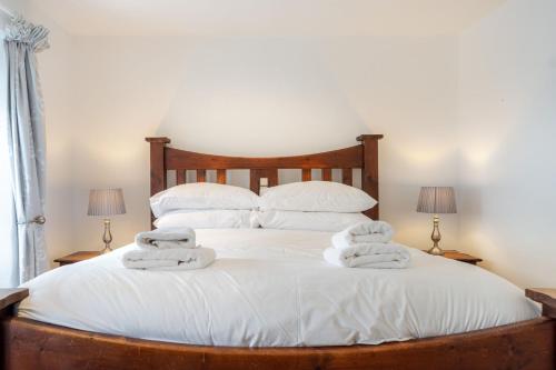 a bedroom with a bed with towels on it at Gingerbread Cottage in Hawkshead