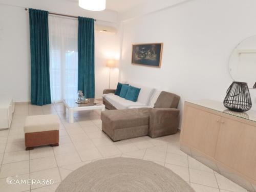 a living room with a couch and a chair at Apartment Ioanna #1 in Kallithea Halkidikis