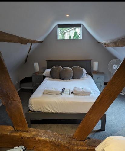 a bedroom with a bed in a attic at The Red Lion & Cellar Room, Betchworth in Betchworth