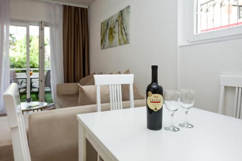 a bottle of wine sitting on a table with two wine glasses at Andrea Lux in Kotor