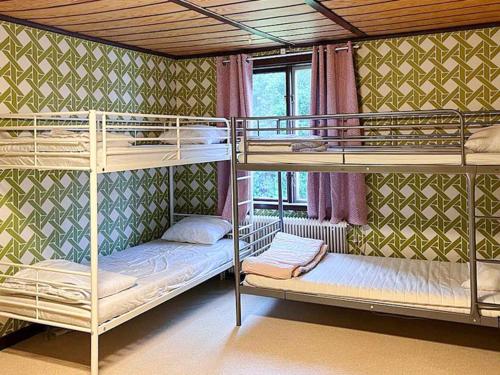 two bunk beds in a room with a window at Holiday home VIKSJÖFORS in Viksjöfors