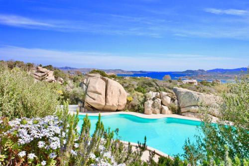 a swimming pool with a view of the ocean at Cottage Sardinia by KlabHouse in Palau
