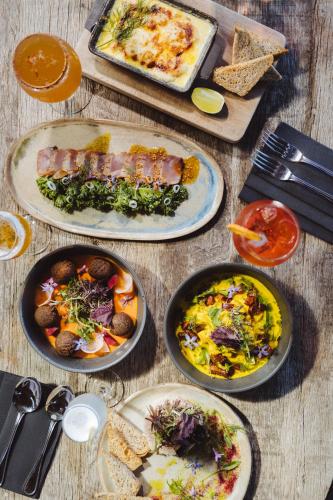 a table topped with plates of food on top at Hotel Alaia in Pichilemu