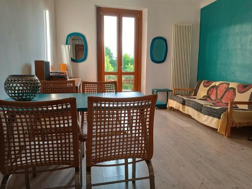 a living room with a table and chairs and a couch at La Casa di Nora in Turin