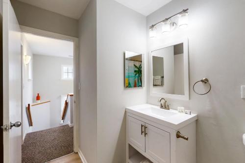 a white bathroom with a sink and a mirror at Barracuda #2B-CAC in Buxton