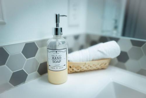 a bottle of hand soap sitting on a bathroom counter at Vegas Hideaway with Jacuzzi & Pool by Strip in Las Vegas
