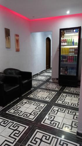 a drink vending machine in a room with a floor at Hotel Ferrari in Sao Paulo