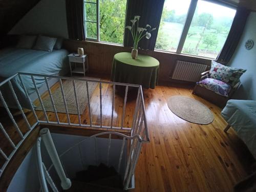a view of a living room with a spiral staircase at Lar A Rola El precio x una noche es para dia y medio Check in 9am Out 21pm in Sabucedo