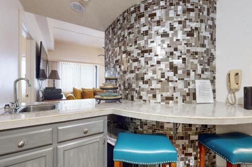 - une cuisine avec un évier et deux tabourets bleus dans l'établissement Sugar Top 2816, à Sugar Mountain