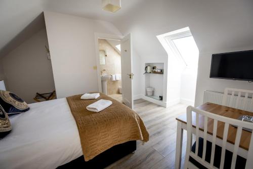 a bedroom with a large bed and a television at Coastal View House in Doolin