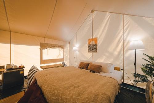 a bedroom with a large bed in a tent at SOL Glamping at Khao yai in Ban Nong Makha