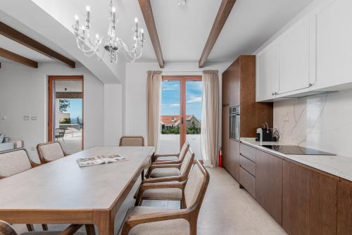 a kitchen and dining room with a table and chairs at Belsize Villas in Budva