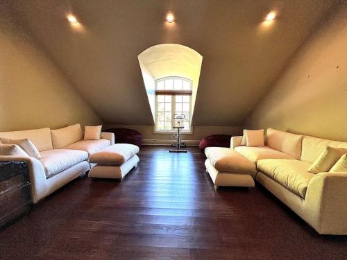 a large living room with couches and a window at Chateau Montreau on Hudson in Newburgh