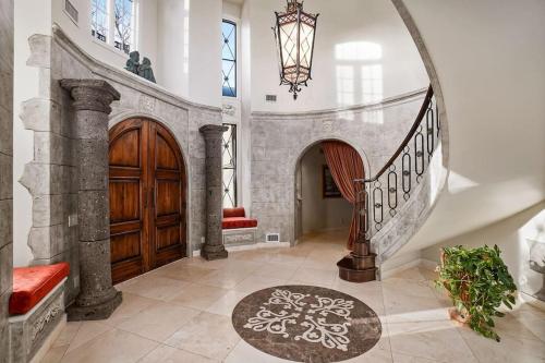 a foyer with a staircase and a wooden door at Chateau Montreau on Hudson in Newburgh