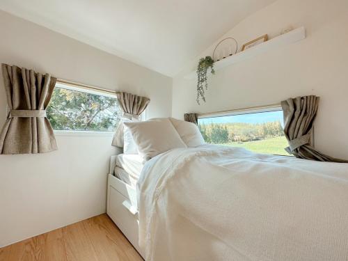 a bedroom with a bed and a window at SOL Glamping at Khao yai in Ban Nong Makha