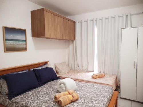 a bedroom with two beds and a large window at Porto de Galinhas - Muro Alto Condomínio Clube in Ipojuca