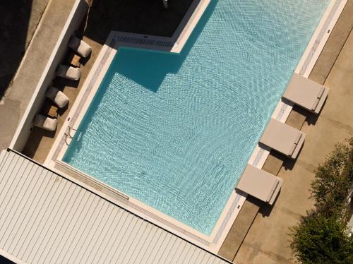an overhead view of a swimming pool with chaise lounge chairs and a swimming pool at Apollo Plakias in Plakias