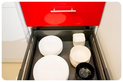 two white toilets in a red box at Qhome 3 - Duplex Cosy entre Paris et Disney - Parking privé in Villiers-sur-Marne