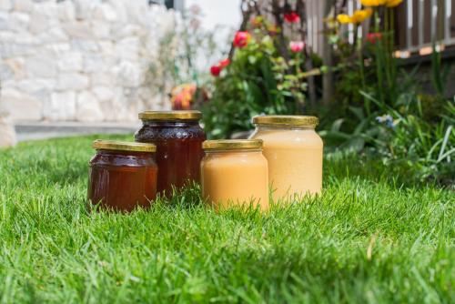 three jars of honey sitting in the grass at Baienhof in Morter