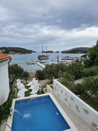 a swimming pool on a balcony with a view of the water at Beach Villa Ema in Rab