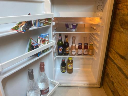an open refrigerator filled with lots of bottles of alcohol at Villa Irma guest house in Crotone