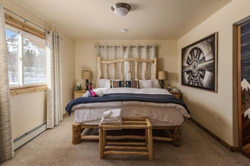 a bedroom with a large bed and a window at Majestic Valley Wilderness Lodge in Sutton