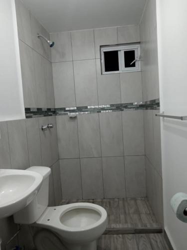 a white bathroom with a toilet and a sink at MI PORTON GRIS in Santa Cruz Tecamac