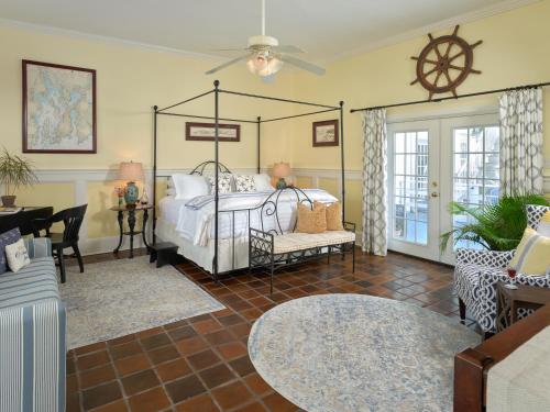 a bedroom with a bed and a living room at Old Manse Inn in Brewster