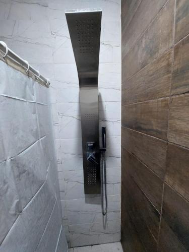 a shower with a glass door in a bathroom at Complejo calle Cordoba Departamento 2 in General Roca