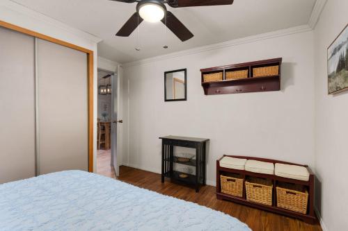 a bedroom with a bed and a ceiling fan at The Sequoia House in Kernville