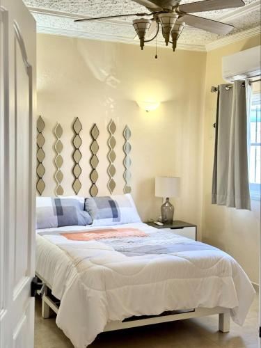a bedroom with a large bed with blue and white at Casa Arcángel SM in Cruz de Huanacaxtle