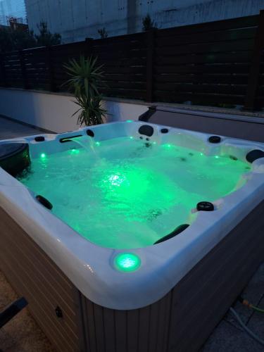 a jacuzzi tub with green liquid in it at Luxury Villa Bueno in Kaštela