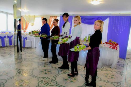 a group of women standing in a room with plates of food at 4 Seasons in Boryspilʼ
