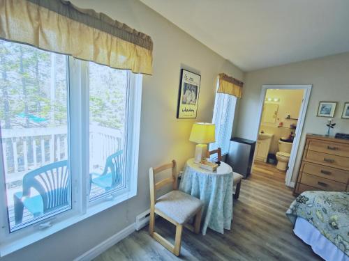 a bedroom with a bed and a large window at 181 Oceanside Inn in Peggy's Cove
