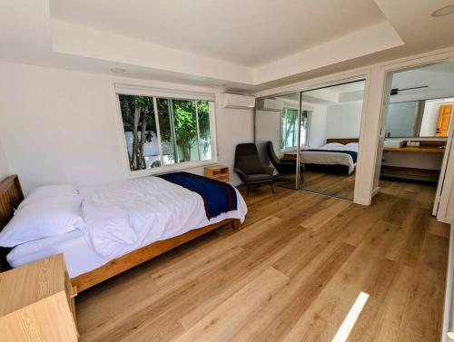 a bedroom with a bed and a desk with a chair at La Jolla Retreat in San Diego