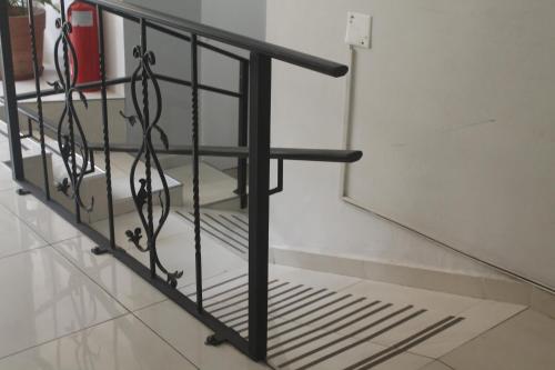 a black metal railing in a room with a wall at Hotel Sienna in Mendoza