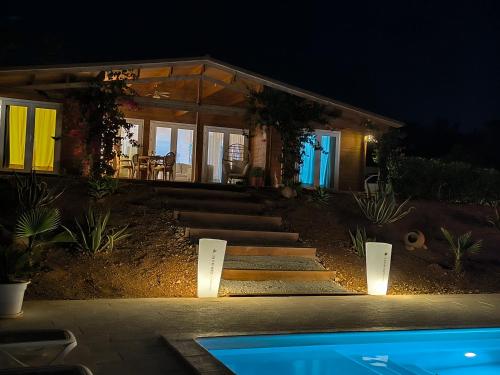 a house with lights in front of it at night at Design Chalet in Albufeira With Private Pool in Albufeira