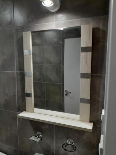 a bathroom with a mirror and a sink at La Celestina in Ramallo