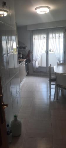 a kitchen with a table and a large window at Pamplona Room in Pamplona