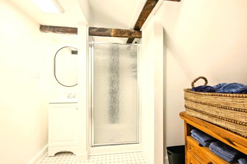 a shower with a glass door in a bathroom at The Cottage Inn At Amos Lake in Preston