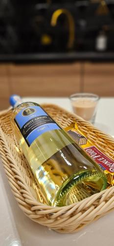 a basket with a bottle of mustard on a table at Apartamenty Natura in Opole
