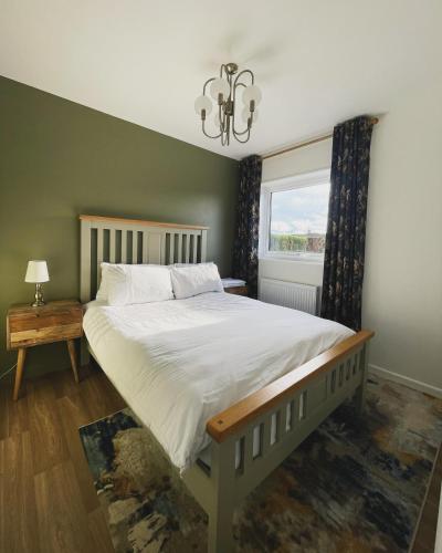 a bedroom with a large bed and a window at Ty Ray Penmaes in Rhayader