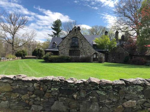 a stone wall in front of a house at Historic Middleburg Equestrian Estate in Middleburg