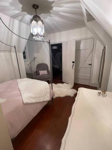 a bedroom with a bed and a chair and a ceiling at Historic Middleburg Equestrian Estate in Middleburg