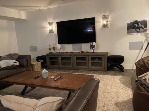 a living room with a flat screen tv on the wall at Historic Middleburg Equestrian Estate in Middleburg